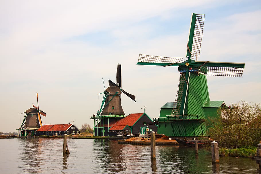 three brown wooden windmill near body of water during daytime, HD wallpaper