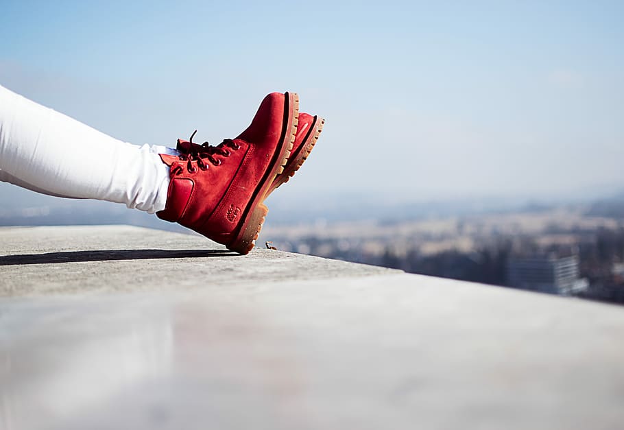 person wearing pair of red boots sitting on building top, person wearing red Timberland leather work boots, HD wallpaper