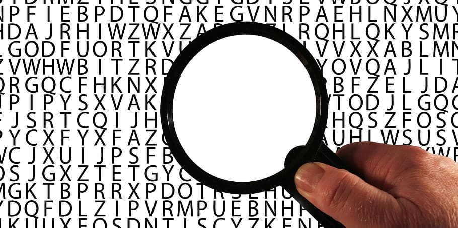 person holding magnifier, alzheimer's, dementia, words, word-finding disorders