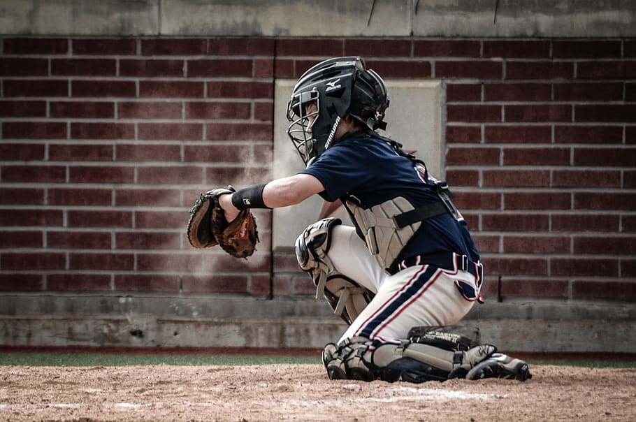 baseball catcher forming to catch ball during daytime, youth