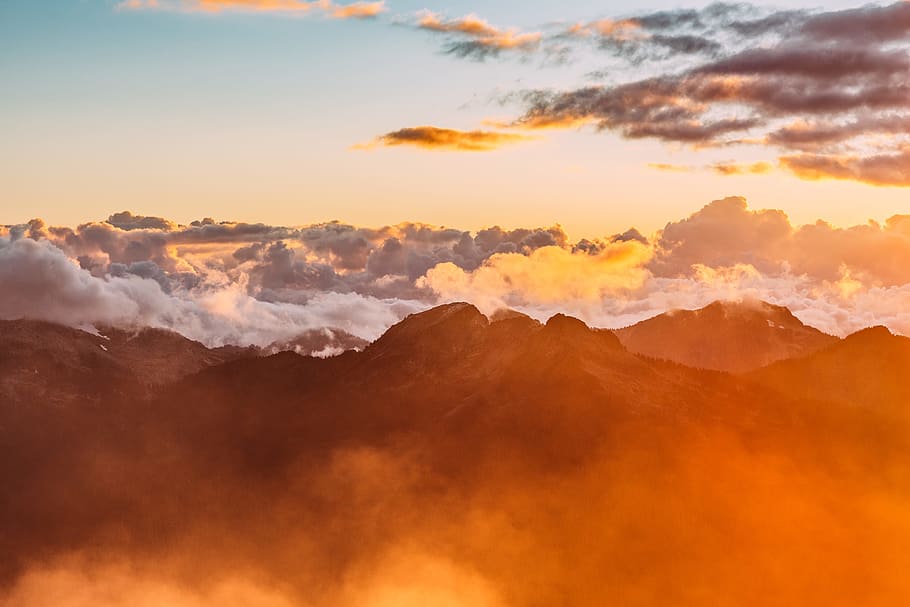 landscape photography of mountains with cloudy skies during golden hour, sea of clouds near mountain