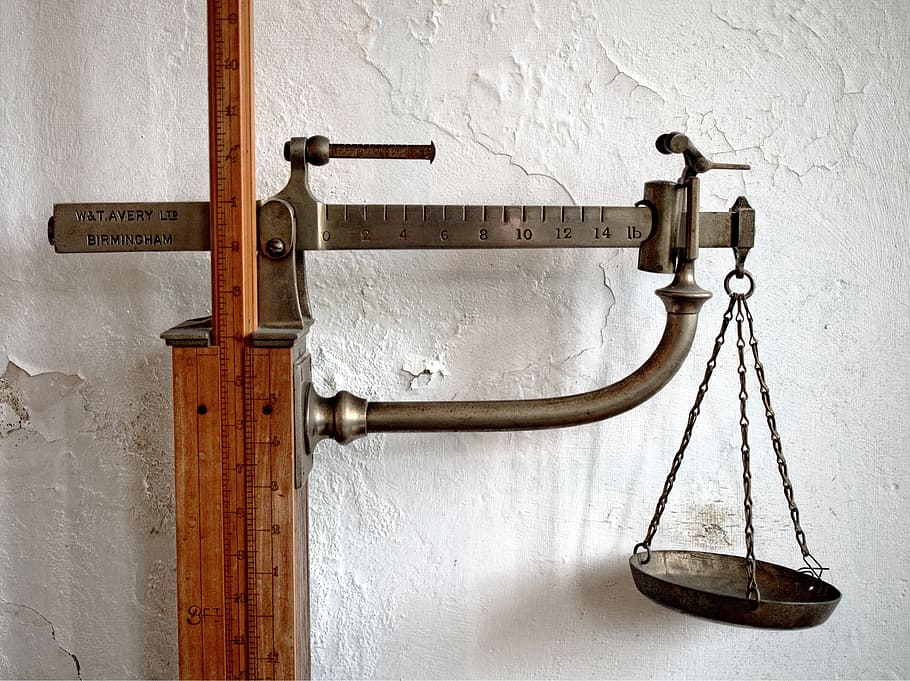brass-colored beam balance scale mounted on wood, scales, weighing