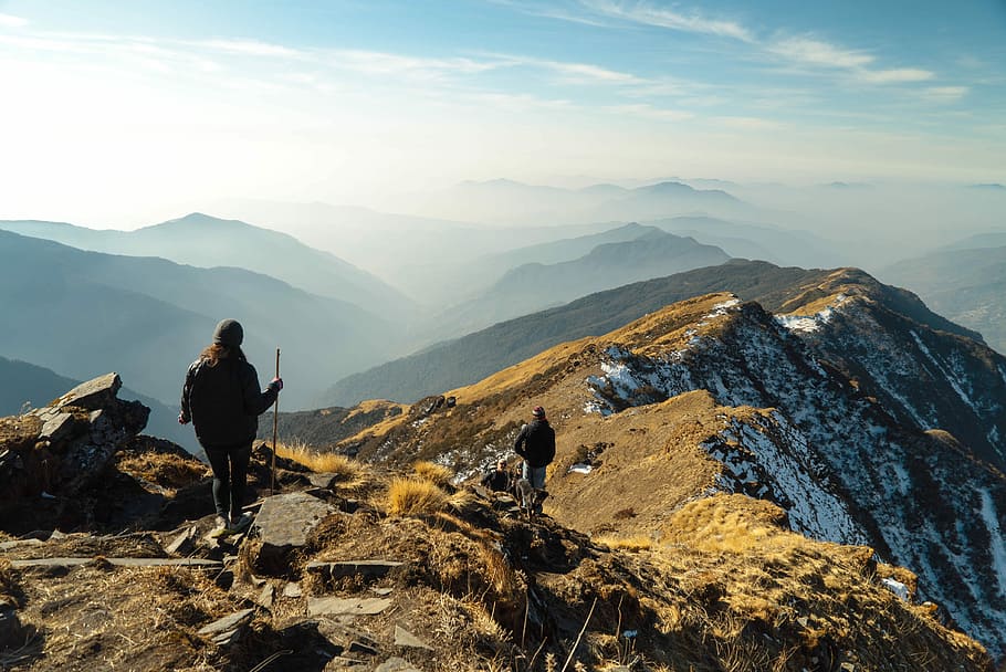 person on top of mountain during daytime, two person walking on peak of mountain HD wallpaper