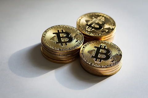 round gold-colored Bitcoins on white surface, finance, currency HD wallpaper