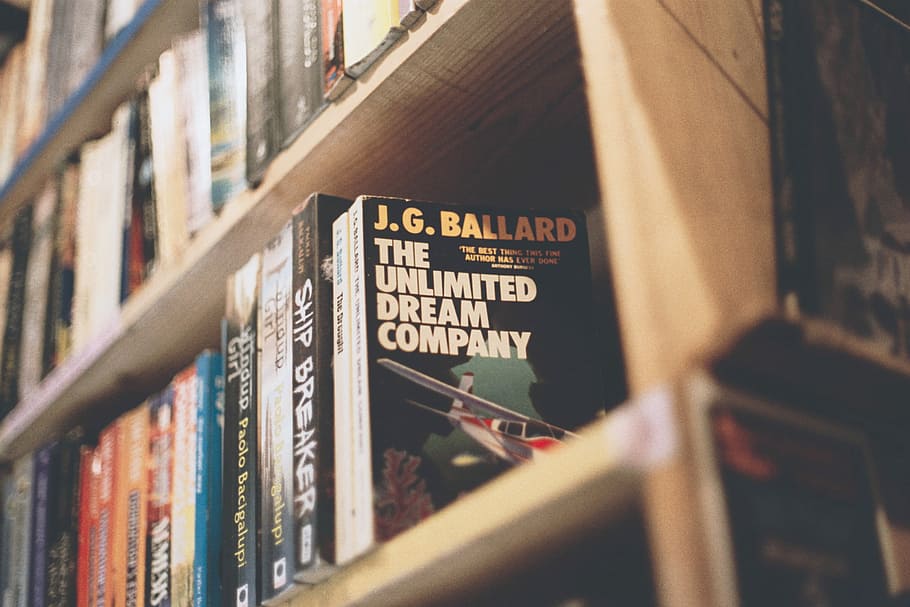 The Unlimited Dream Company by J.G. Ballard book, assorted-title books on brown wooden bookcase, HD wallpaper