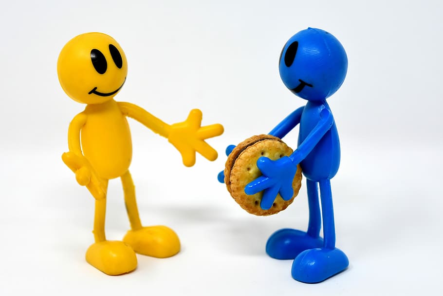 yellow and blue stick man holding biscuit figurines, friends
