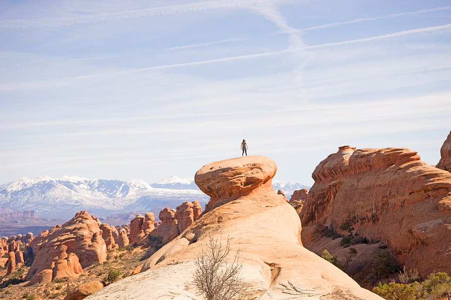 person on top of canyon, photo of person standing on rock, Arches HD wallpaper