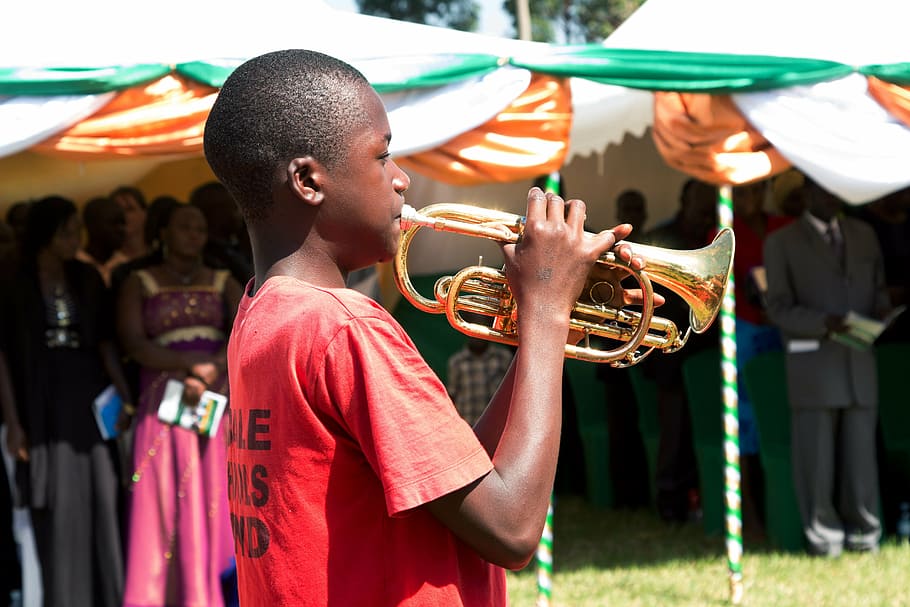 boy playing trombone, people of uganda, children of uganda, africa