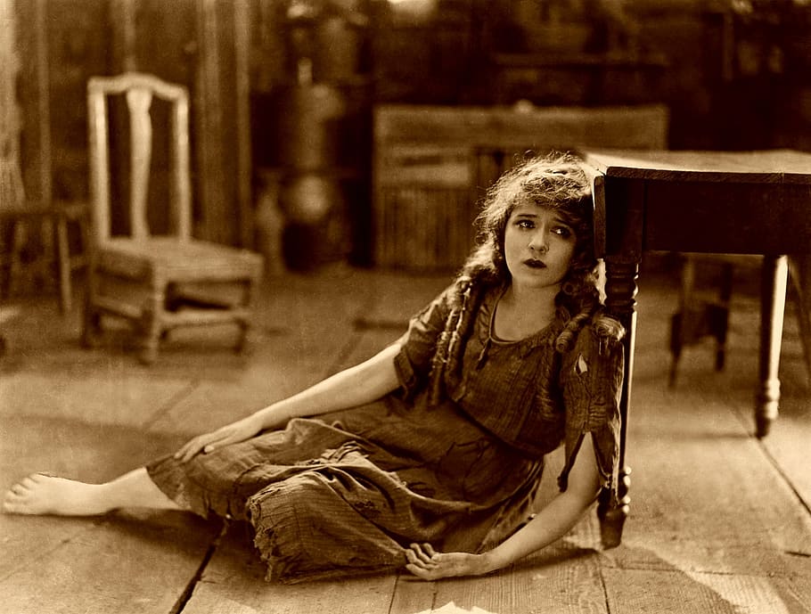 woman leaning on wooden table sepia photography, mary pickford