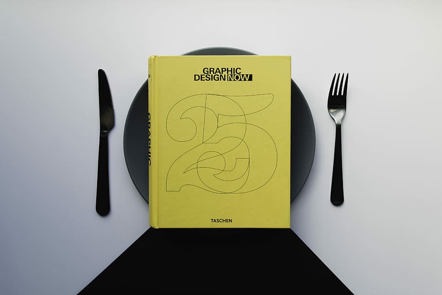 Graphic Design now book on black plate, yellow book on black ceramic plate HD wallpaper