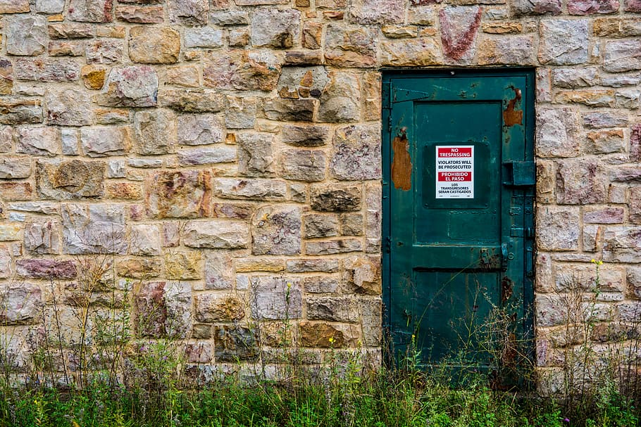closed green door of brown concrete building, grass, brick HD wallpaper