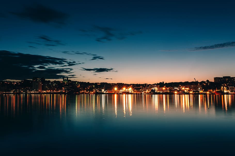 buildings and body of water, cityscape photography with clear skies and calm waters HD wallpaper