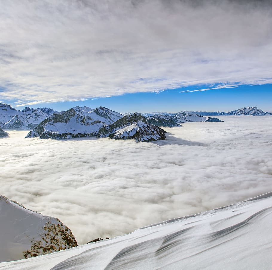 aerial photography of snow-capped mountains at daytime, summit