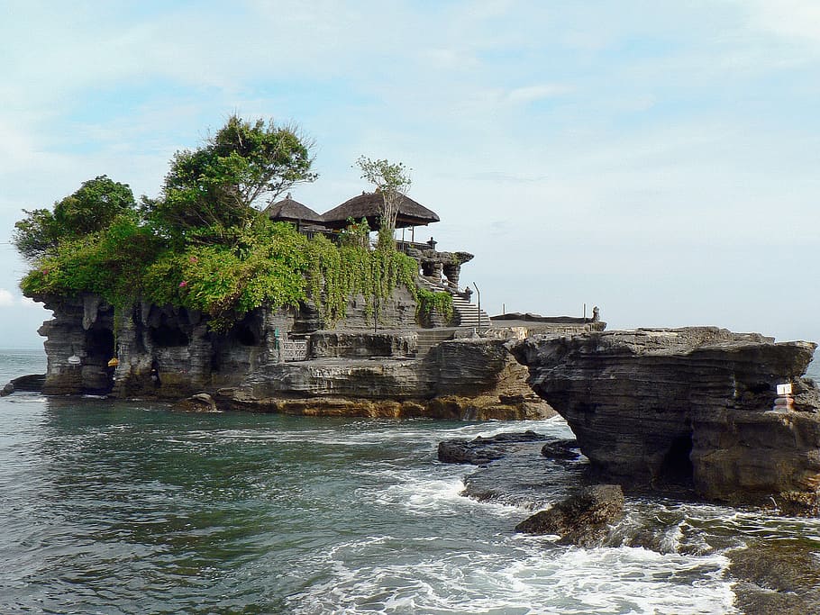 brown cottage on cliff surrounded with water, Indonesia, Bali