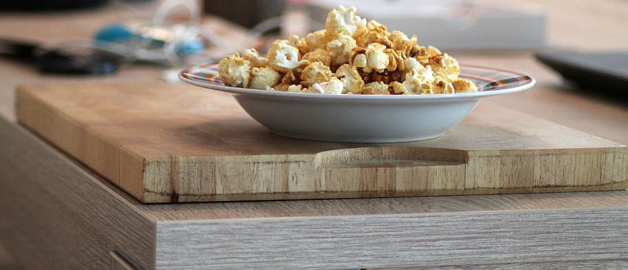 bowl of popcorn on brown wooden board, plate, art, food, fair HD wallpaper
