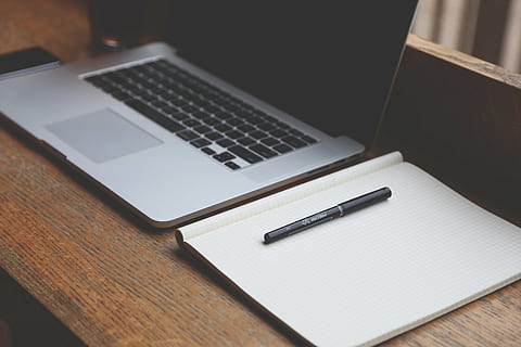 black pen on graphing paper beside Macbook Pro, startup, start-up HD wallpaper