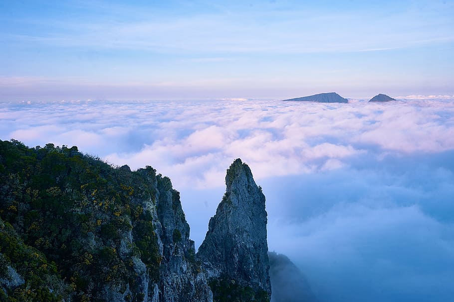 gray and green mountain surrounded by white clouds during daytime HD wallpaper