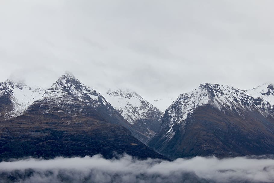 snow-capped mountain in mist, brown and white mountains above clouds HD wallpaper