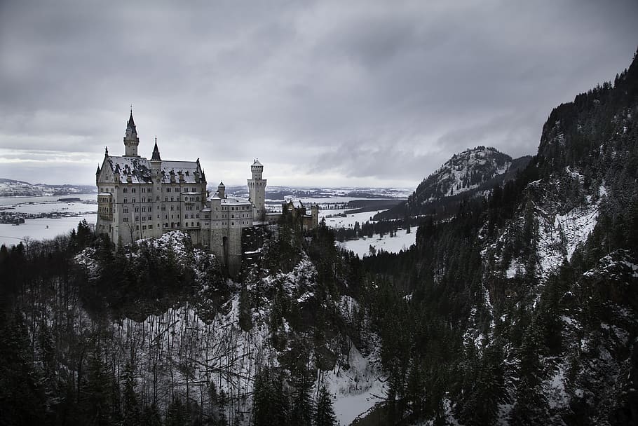 grayscale photo of concrete building on rocky mountains covered with snow, white castle HD wallpaper