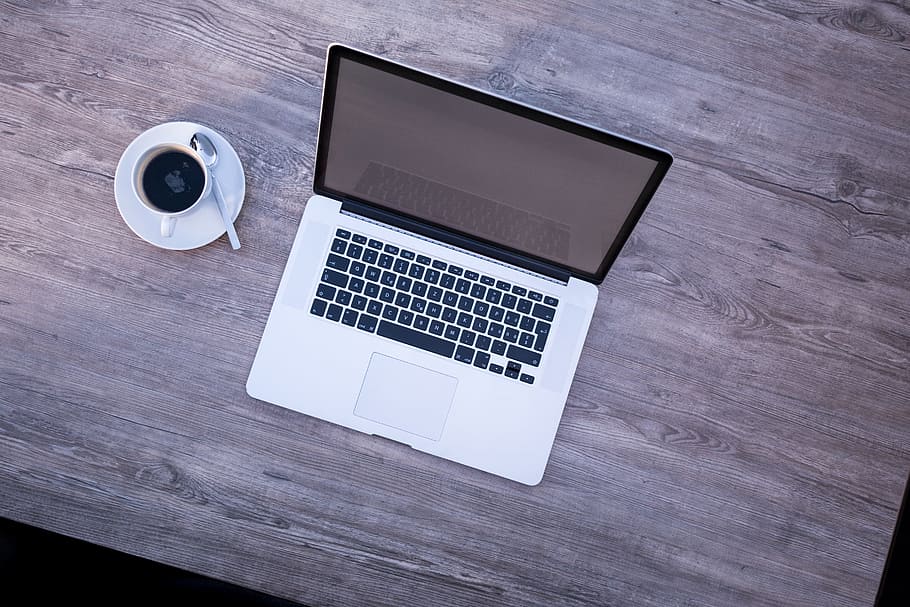 MacBook beside white coffee cup, laptop, mockup, webinar, open