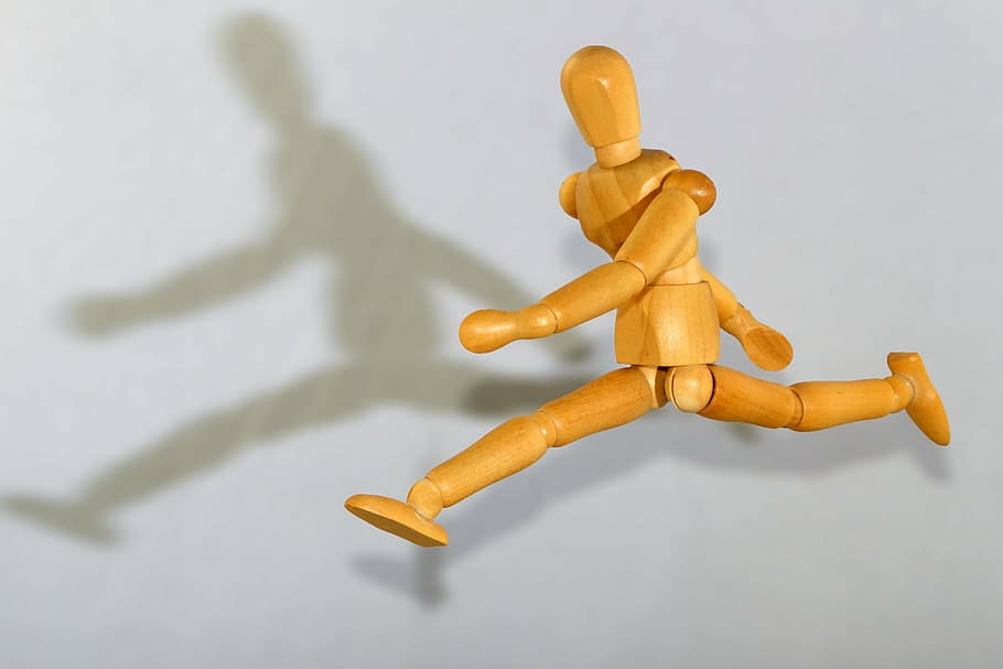 brown manikin forming jump position with shadow on wall, figure HD wallpaper