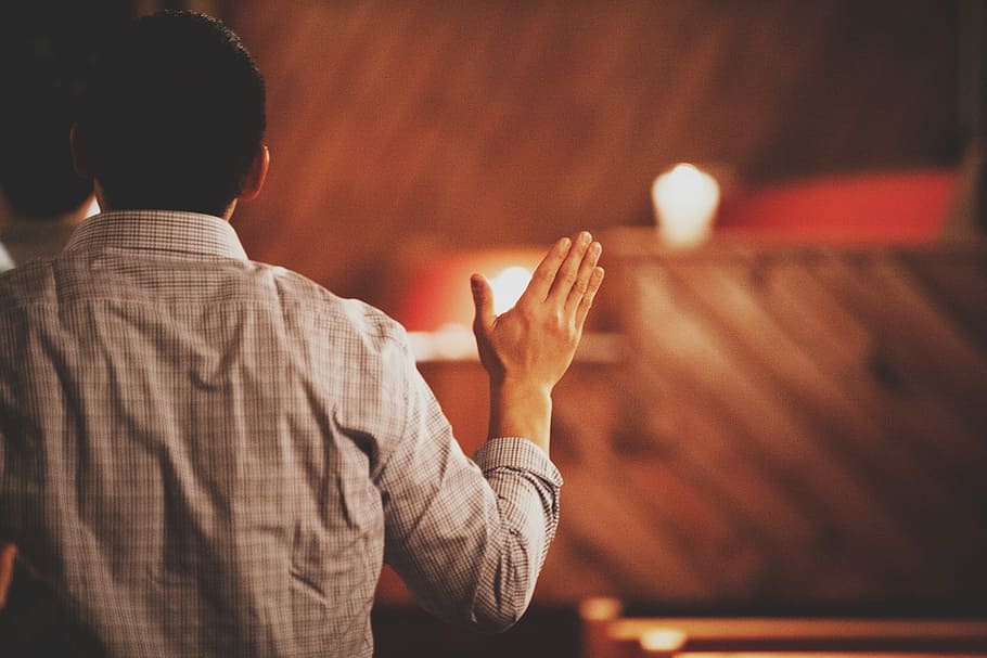 person raising hand, man raising his hands, worship, church, from behind