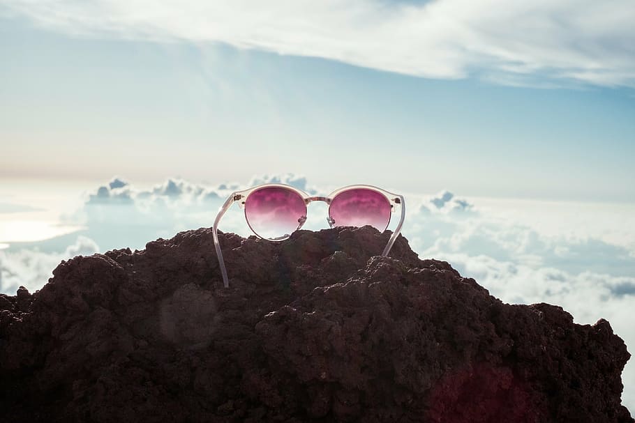 white framed sunglasses on rock overlooking clouds, rocks, hill HD wallpaper