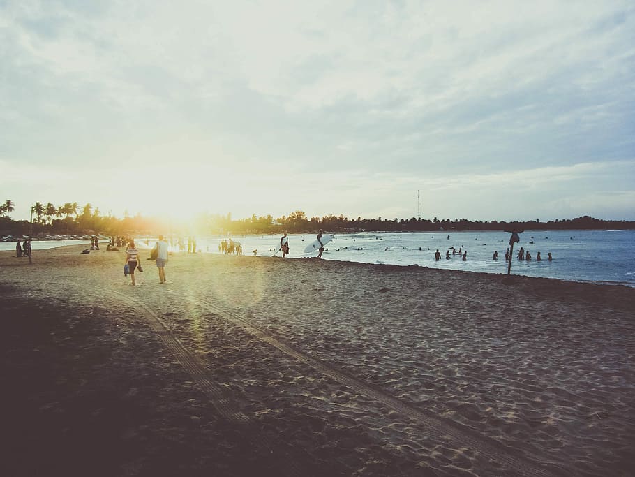 people walking on seashore during daytime, people on body of water and shore during daytime HD wallpaper