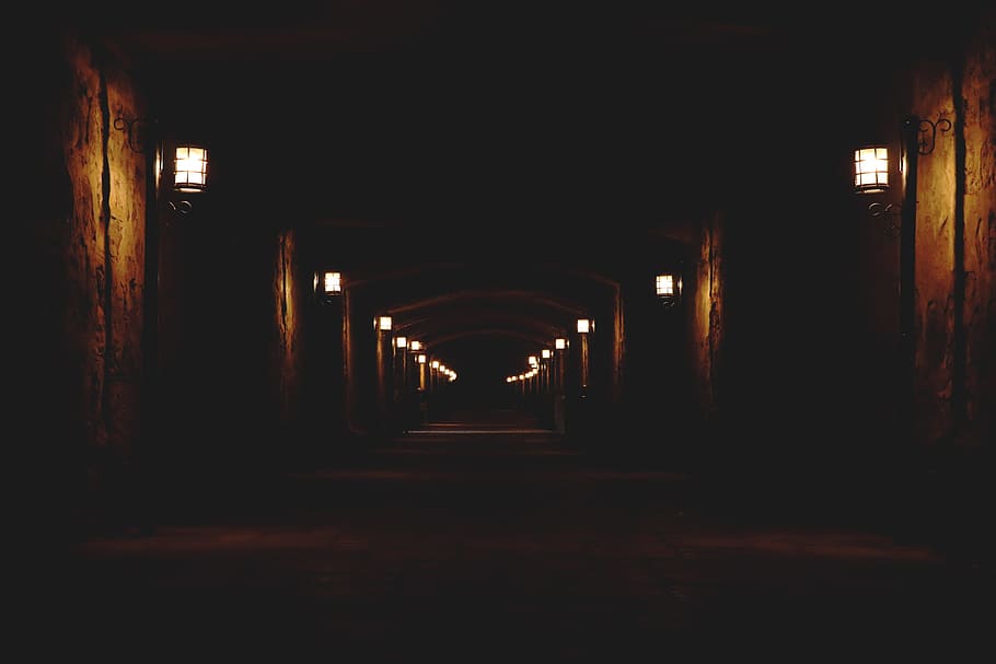 concrete hallway with lighted wall lamps, cave with white sconces, HD wallpaper