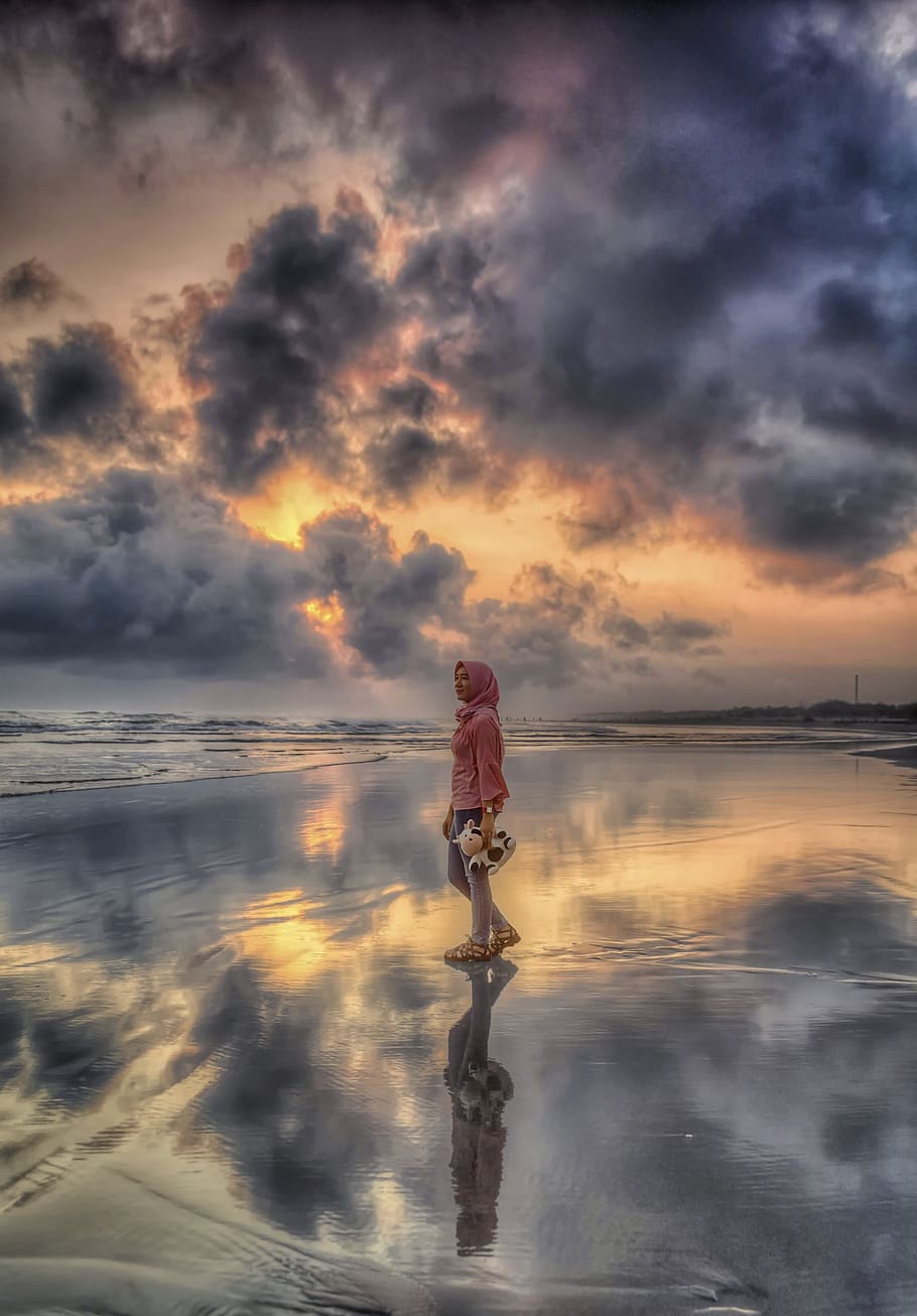 illusion photography of woman standing on body of water, sunset HD wallpaper