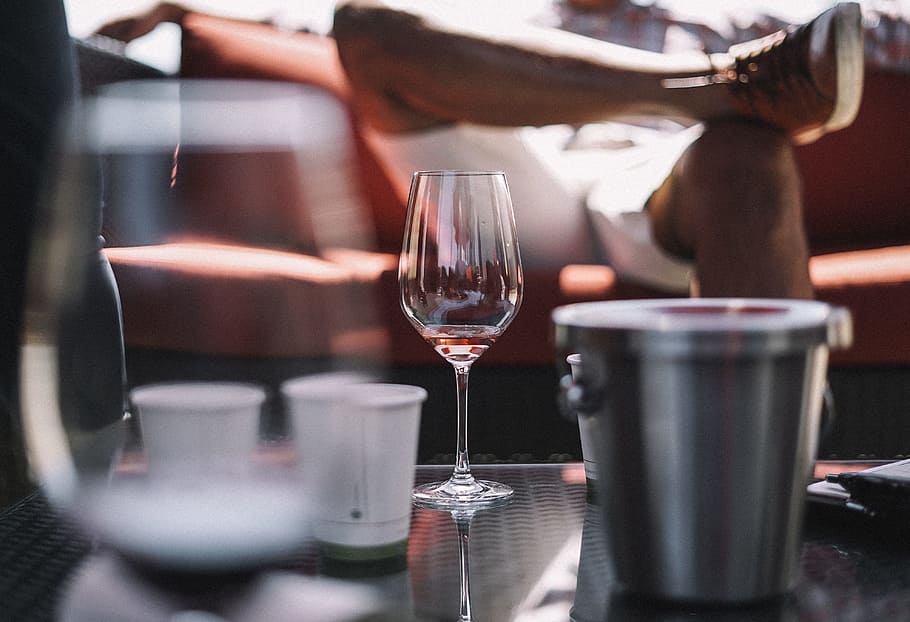 wine glass, ice bucket, and two white cups on table, selective focus photography of wine glass beside bucket, HD wallpaper