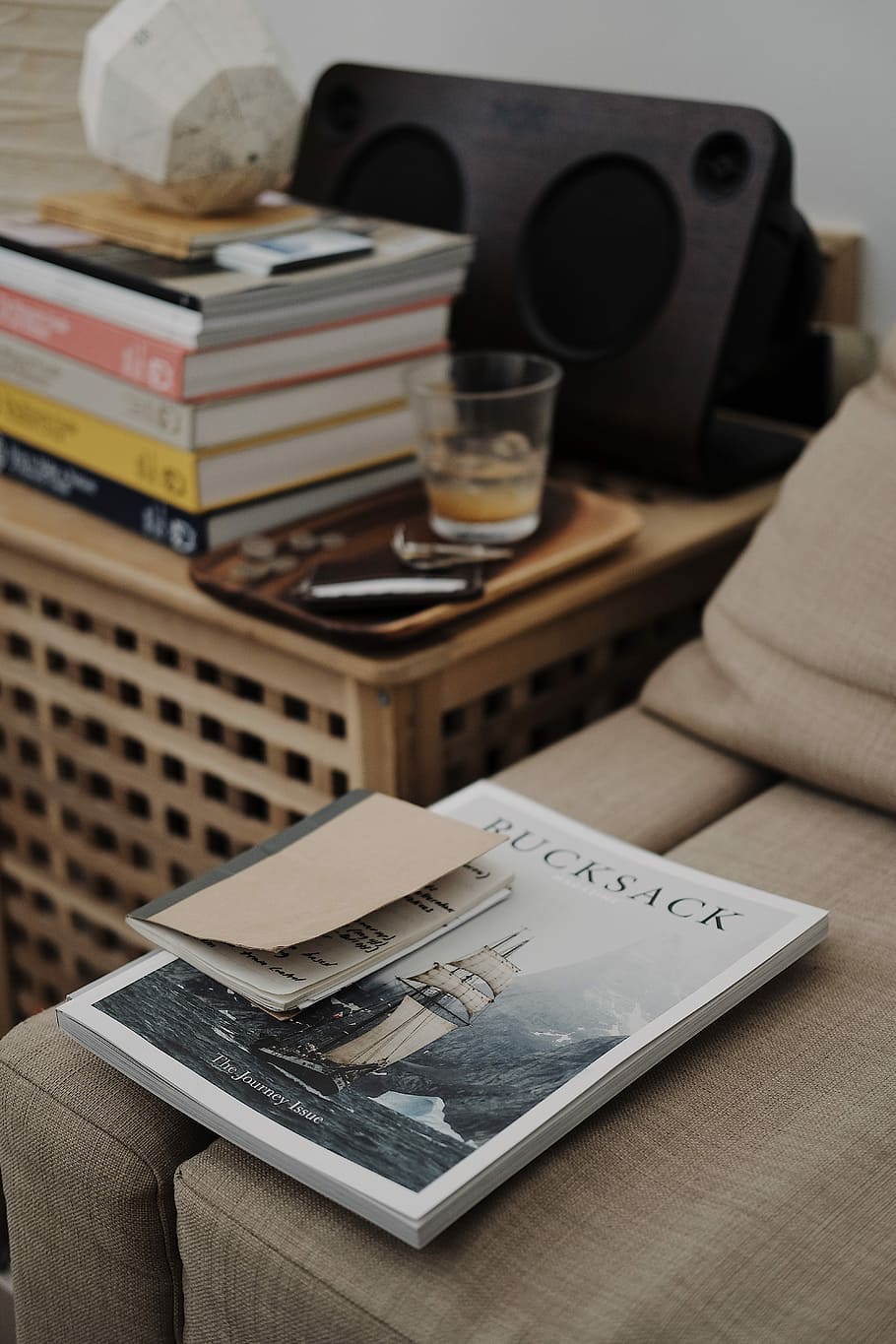 Bucksack book on brown sofa, Bucksack book on bed beside table HD wallpaper