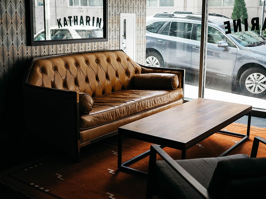 gray SUV parked outside building, brown leather sofa near clear glass wall HD wallpaper