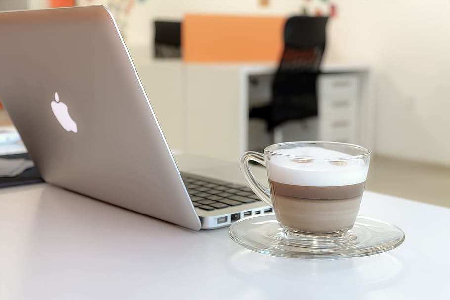 cup of cappuccino beside silver MacBook, laptop, computer, modern HD wallpaper