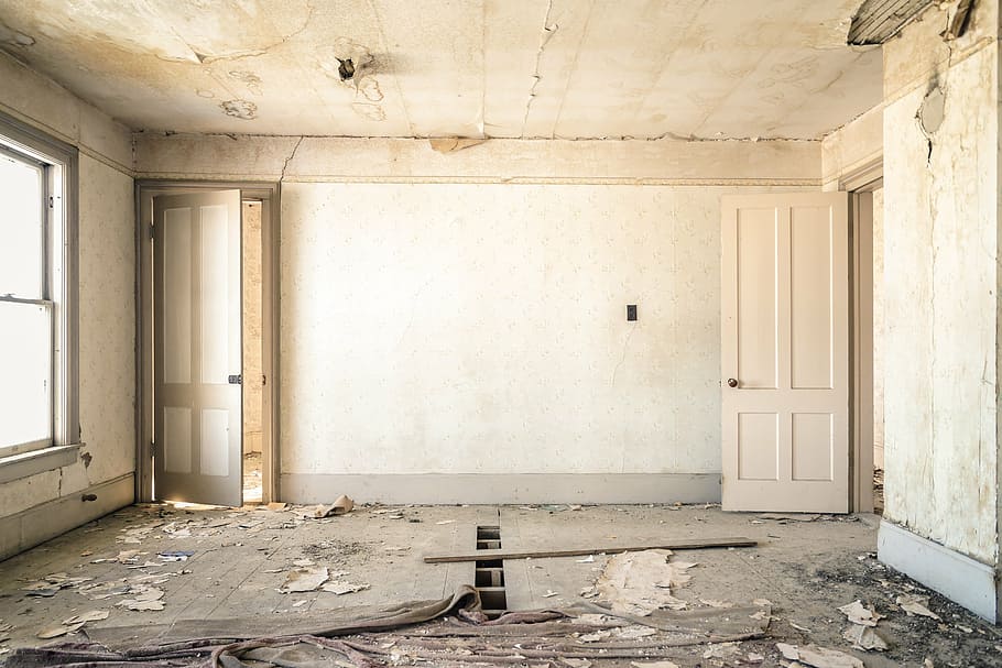 empty white painted wall room with opened door, wreck, construction