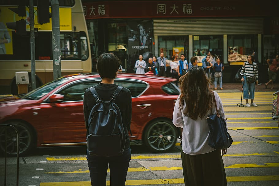 man and woman standing near red car, man and woman standing beside pedestrian lane, HD wallpaper