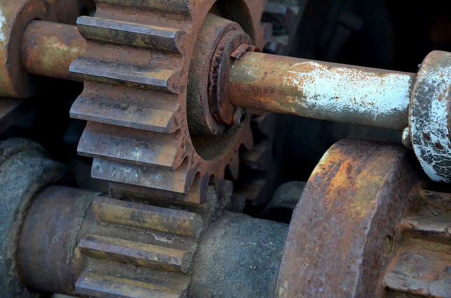 closeup photo of brown and white machine gears, claw, cogwheel
