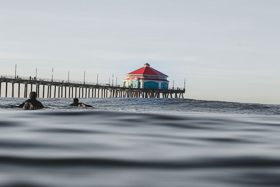sea, ocean, water, waves, nature, people, swimming, bridge HD wallpaper