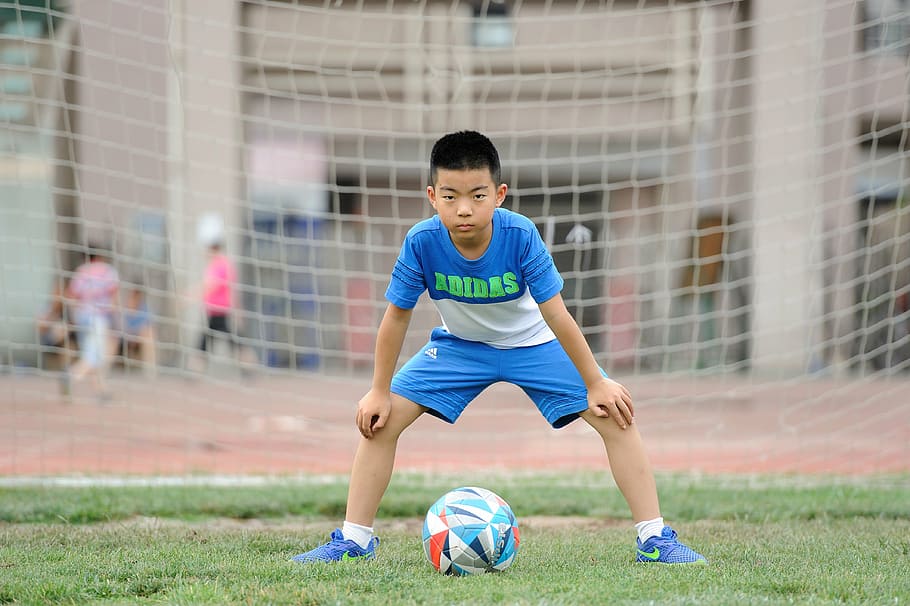 boy guarding soccer goal, football, teenager, greenery, sports