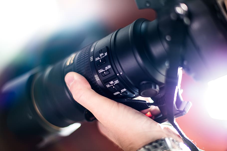 selective focus photography of person wearing black DSLR camera HD wallpaper