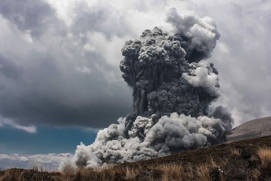 plinian volcanic eruption photograph, grey smoke on clouds, volcano