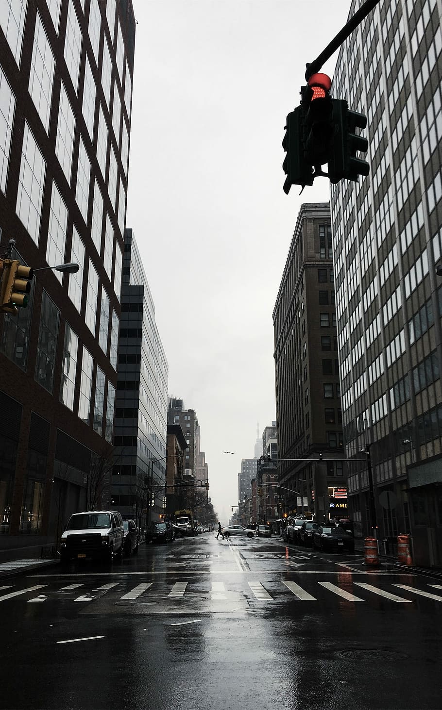 vehicles on grey wet road between buildings during daytime, white vehicle park near pedestrian lane HD wallpaper