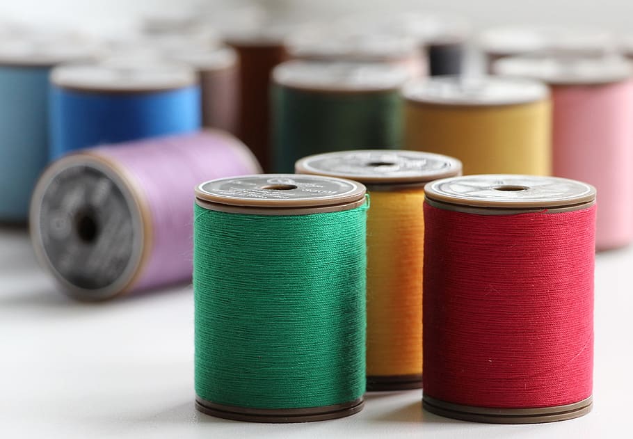 assorted-color thread lot on white surface, needlework, handmade HD wallpaper