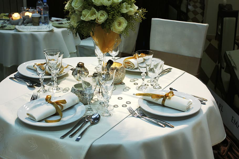 plates, utensils, and napkins on table, dining table, table cutlery