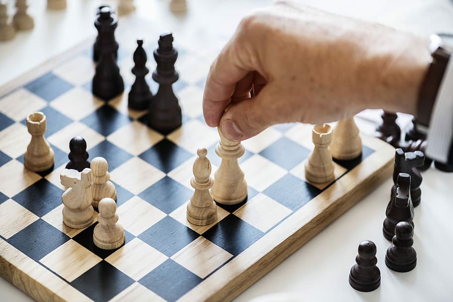 person moving white chess piece, game, leisure games, board game HD wallpaper
