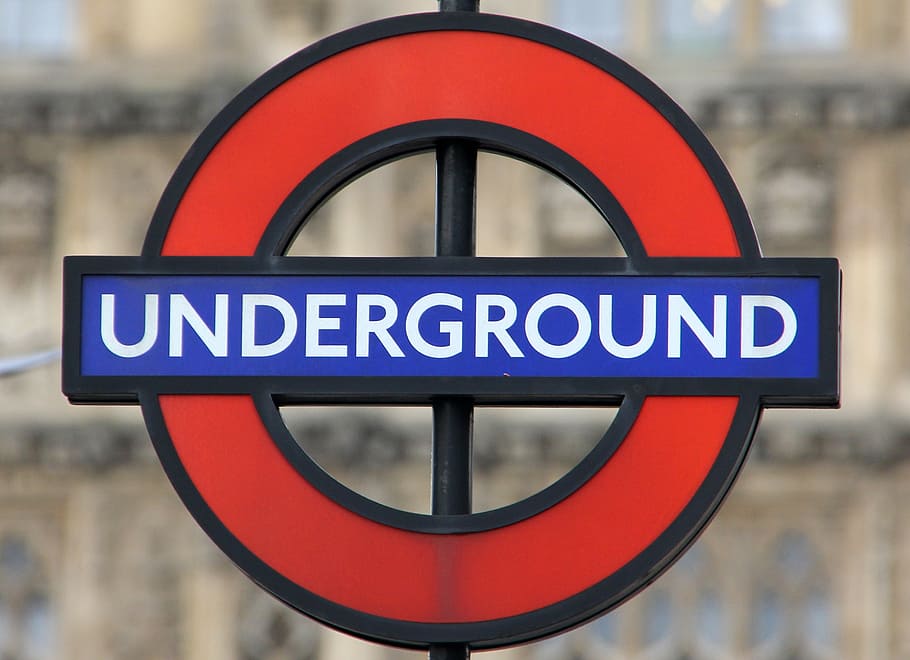 selective focus photography of blue and red Underground signage HD wallpaper