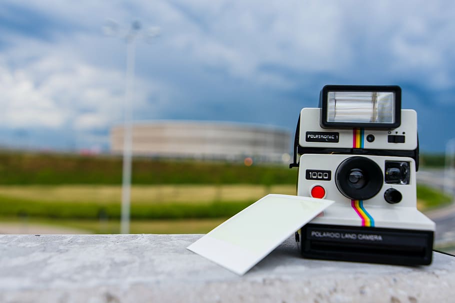white Polaroid land camera beside photo at daytime, photography HD wallpaper