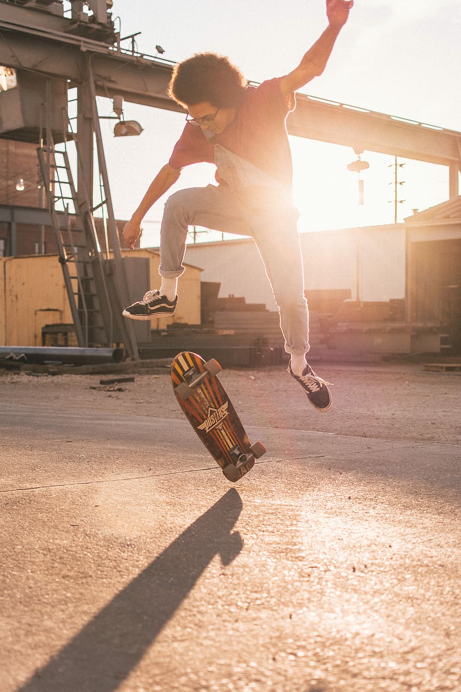 man skate boarding during daytime, man doing skateboard tricks on concrete flooring HD wallpaper