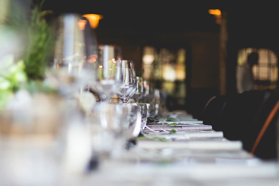 focused photo of wine glasses lined on table, selective focus photography of wine glasses table arrangement HD wallpaper