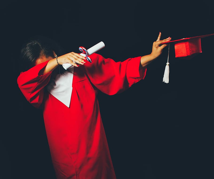 person wearing red graduation dress, woman wearing academic dress while doing dub